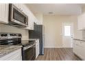 Modern kitchen with stainless steel appliances, granite countertops, and sleek cabinets at 4417 Roche St, Atlanta, GA 30349