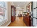 Inviting entryway with hardwood floors, elegant furnishings, and views into the dining room at 11715 Dancliff Trce, Alpharetta, GA 30009