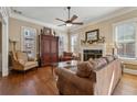 Cozy living room featuring a fireplace, hardwood floors, and comfortable seating arrangements at 11715 Dancliff Trce, Alpharetta, GA 30009