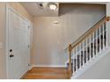 Inviting entryway features hardwood floors, staircase, and neutral paint, creating a bright and welcoming space at 1405 Bramlett Forest Trl, Lawrenceville, GA 30045