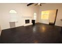 Spacious living room with dark hardwood floors and a white painted brick fireplace at 185 Windhaven Sw Trl, Atlanta, GA 30331