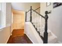 Inviting entryway with hardwood floors, carpeted stairs, and natural light from the window at 2195 Edison Ne Ave, Atlanta, GA 30305