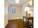 Hallway with hardwood floors, neutral walls, white trim, and a decorative table at 2195 Edison Ne Ave, Atlanta, GA 30305