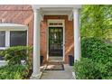 Welcoming front entry featuring a black door, white columns, and lush landscaping at 2329 Marion Walk Se Dr # 5, Atlanta, GA 30339