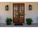 Elegant double front doors flanked by decorative lanterns and potted plants at 2373 Sagamore Hills Dr, Decatur, GA 30033