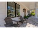 Inviting front porch featuring wood rocking chairs and brick flooring details at 2373 Sagamore Hills Dr, Decatur, GA 30033