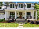 Charming front porch with rocking chairs, brick flooring, and a double-door entry at 2373 Sagamore Hills Dr, Decatur, GA 30033