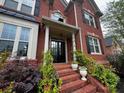 Charming front entry with brick steps, decorative columns, and lush plants enhancing curb appeal at 2688 Hidden Falls Ne Dr, Buford, GA 30519