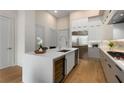 Contemporary kitchen featuring a wine fridge, stainless appliances, and a quartz countertop island at 40 12Th Ne St # 803, Atlanta, GA 30309
