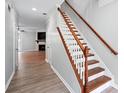 Open entryway with hardwood floors, staircase, and view into the living area with fireplace at 5019 Lower Elm St, Atlanta, GA 30349