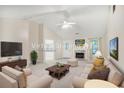 Bright living room boasts vaulted ceilings, a fireplace, and an open layout perfect for entertaining at 75 Saltcreek Pt, Sugar Hill, GA 30518