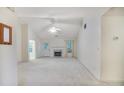 Bright living room with vaulted ceilings, a ceiling fan, and a marble fireplace, perfect for entertaining at 75 Saltcreek Pt, Sugar Hill, GA 30518