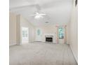 Bright living room with vaulted ceilings, a ceiling fan, and a marble fireplace, perfect for entertaining at 75 Saltcreek Pt, Sugar Hill, GA 30518