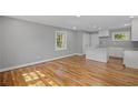 Spacious living room featuring new hardwood floors, white trim, and plenty of natural light at 2889 Macon Sw Dr, Atlanta, GA 30354