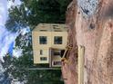 View of modern two-story home under construction with heavy equipment on site at 2918 Level Ridge Rd, Atlanta, GA 30354