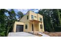 Modern two-story house with an attached garage and an unfinished yard at 2918 Level Ridge Rd, Atlanta, GA 30354