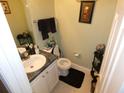 Well-maintained half bathroom with a granite countertop and decorative fixtures at 6179 Swabia Ln, Stone Mountain, GA 30087