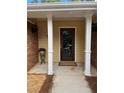 Covered front porch with decorative door and nice accents including a small flower stand at 1818 Brandy Woods Se Dr, Conyers, GA 30013