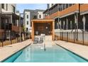 Community pool area features lounge chairs, grill, and cooking area, surrounded by black metal fencing at 307 Cedar Dust Dr, Decatur, GA 30030