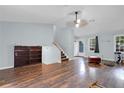 Bright living room featuring wood flooring, a staircase, and windows bringing in natural light at 3178 Booths Ct, Dacula, GA 30019