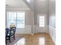Formal dining area featuring hardwood floors, wainscoting, and a view to the backyard at 4765 Silver Leaf Dr, Cumming, GA 30040