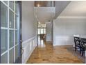 Elegant foyer with hardwood floors, wainscoting, and a view into the formal dining and living spaces at 4765 Silver Leaf Dr, Cumming, GA 30040