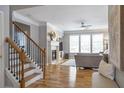 Bright living room with hardwood floors, fireplace, and large windows offering plenty of natural light at 4765 Silver Leaf Dr, Cumming, GA 30040