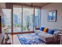 Comfortable living room with cityscape views, a modern sofa, and ample natural light at 860 Peachtree Ne St # 1411, Atlanta, GA 30308