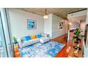 Cozy living room with modern furnishings, a decorative rug and access to other rooms at 860 Peachtree Ne St # 1411, Atlanta, GA 30308