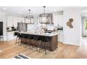 Modern kitchen with stainless steel appliances, large center island with seating, and stylish pendant lights at 1248 Windmill Pkwy # 240, Cumming, GA 30041