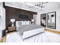 This main bedroom features a coffered ceiling, wood accent wall, and bright natural light at 1248 Windmill Pkwy # 240, Cumming, GA 30041