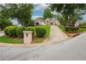 Inviting curb view with manicured bushes and an elegant driveway leading to a well-maintained home at 65 Wisteria Blvd, Covington, GA 30016