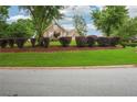 Well-maintained front yard showcasing lush greenery, mature trees, and tidy landscaping at 65 Wisteria Blvd, Covington, GA 30016