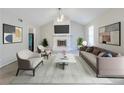 Inviting living room with a cozy fireplace, vaulted ceiling, and stylish modern decor at 6595 Oakwood Dr, Douglasville, GA 30135
