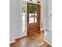 Wood front door with sidelights that open up to hardwood floors at 209 Wildwood Way, Canton, GA 30114