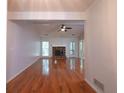Open-concept living room showcases a fireplace, hardwood floors and great natural light at 3177 Westfield Ne Way, Roswell, GA 30075