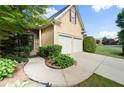 Driveway leading to a two-car garage, complemented by mature landscaping at 4085 Tritt Homestead Dr, Marietta, GA 30062