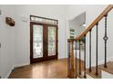 Foyer featuring hardwood floors, a stained glass door, and staircase with wood and iron banister at 4085 Tritt Homestead Dr, Marietta, GA 30062