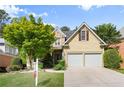 Inviting home exterior with stone accents, two-car garage, and lush green lawn at 4085 Tritt Homestead Dr, Marietta, GA 30062