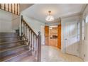 Welcoming foyer with hardwood stairs and decorative lighting fixture at 5124 Vermack Rd, Dunwoody, GA 30338