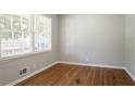 Light-filled bedroom featuring hardwood floors, fresh paint and a large window at 802 San Miguel Dr, Stone Mountain, GA 30083