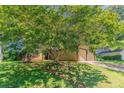 Charming home with a two-car garage surrounded by lush trees and greenery at 1074 Cherokee Hts, Stone Mountain, GA 30083