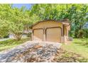 Detached two-car garage with a concrete driveway and manicured lawn at 1074 Cherokee Hts, Stone Mountain, GA 30083