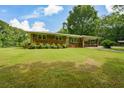 A classic brick home with a sprawling front yard and covered parking at 232 Hembredge Dr, Canton, GA 30115