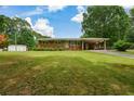 Well-maintained brick home with a spacious front yard and covered carport at 232 Hembredge Dr, Canton, GA 30115