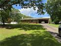 All brick home with a level yard, a carport, and a detached storage building at 232 Hembredge Dr, Canton, GA 30115