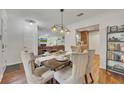 Dining room showcases a modern table setting adjacent to a beautiful living room at 301 Mill Pond Se Ct, Smyrna, GA 30082