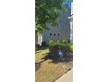 Neatly landscaped side yard with green grass and an ADT security sign at 5726 Silver Lake Dr, Mableton, GA 30126