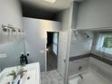 Bright bathroom features a sleek vanity, a tiled shower-tub combo, and lots of natural light at 6325 Stablewood Way, Lithonia, GA 30058