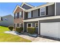 Two-story home with brick and gray facade, neat front yard and a two-car garage at 209 Courtland Oaks Sw Dr, Marietta, GA 30060